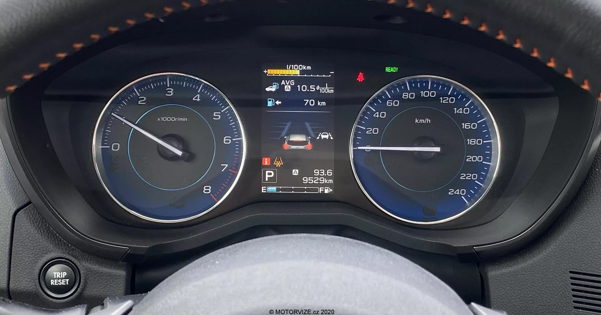 Közelről a Subaru XV 1.6i Trend Lineartronic műszerfaláról, amely egy analóg fordulatszámmérőt, egy digitális többfunkciós kijelzőt és egy analóg sebességmérőt mutat. A központi digitális kijelző az üzemanyagszint jelzőt, a jármű állapotát, a külső hőmérsékletet 10,5°C-kal, egy karbantartási figyelmeztetést, a parkoló állású sebességváltót, a 95 249 km-es kilométeróra állását és az időt 9:36-kor mutatja. Az kép a műszerfalat a vezető üléséből rögzíti, további részletekkel, mint például a bal oldali fény- és irányjelző vezérlő kar és a kormánykerék részleges kilátása hüvelykujjtámasszal és varrással.